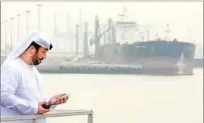  ?? KARIM SAHIB/AFP ?? An Emirati man at the Fujairah oil terminal, a dock for supertanke­rs.