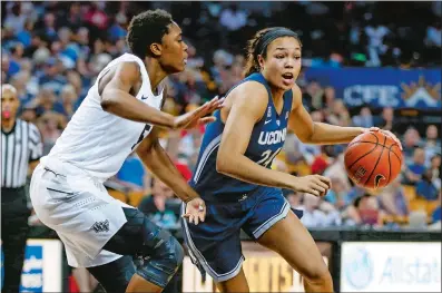  ?? REINHOLD MATAY/AP PHOTO ?? UConn forward Napheesa Collier (24) drives around Central Florida forward Masseny Kaba (5) during the second half of Sunday’s game at Orlando, Fla. Collier scored 18 points and UConn won 78-41.