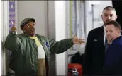  ?? KATHY WILLENS — ASSOCIATED PRESS ?? Director Spike Lee, left, gestures in a hallway at Madison Square Garden Monday while arguing with security guards who didn’t want to let him access his courtside seat.