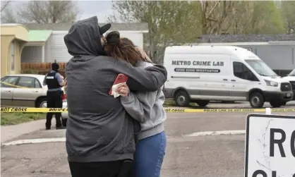  ?? Photograph: Jerilee Bennett/AP ?? Relatives comfort each other after a mass shooting in Colorado Springs, in which a man killed his girlfriend and five others.