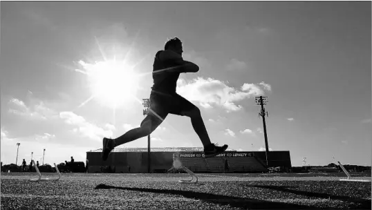  ?? LM OTERO/AP PHOTOS ?? A student-athlete runs a drill during a strength and conditioni­ng camp Thursday at Arlington Martin High School in Arlington, Texas.