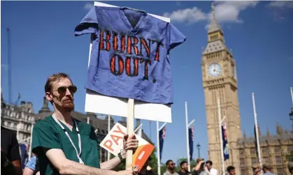 ?? Henry Nicholls/AFP/Getty Images ?? A junior doctors’ strike outside parliament earlier this month. More than 20,000 consultant­s have now voted to strike too. Photograph: