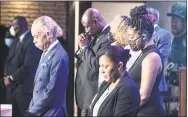  ?? Kerem Yucel / Getty Images ?? U.S. civil rights leader Al Sharpton, left, stands with others as they bow their heads during a memorial service in honor of George Floyd on Thursday at North Central University's Frank J. Lindquist Sanctuary in Minneapoli­s.