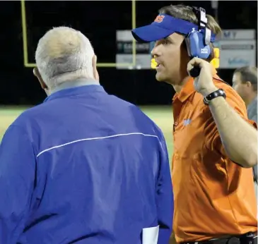  ?? (Photo by Jason Cleveland, SDN) ?? Starkville Academy coach Chase Nicholson, right, confers with assistant coach Tony Stanford during last week's 21-13 win over Leake Academy.