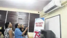  ?? ?? Beneze Barker-dunn (second left), vice principal at Holy Trinity High School showcases the features of the new air conditioni­ng unit to Carolyn Bell-wisdom (left), partner and ESG lead at PWC Jamaica, and Dana Coley, senior associate, advisory at PWC Jamaica.