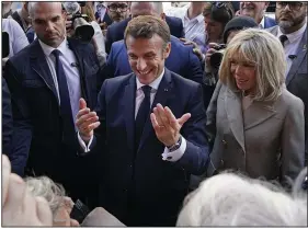  ?? (AP/Gerald Herbert) ?? French President Emmanuel Macron and his wife, Brigitte Macron, greet the crowd as they arrive Friday at Jackson Square in New Orleans.
