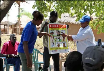 ??  ?? In this Feb. 26 photo, health workers give a training presentati­on about how to detect and prevent the spread of Ebola, in an army barracks outside South Sudan’s town of Yei. AP Photo/ SAm medrIck