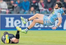  ??  ?? Glasgow’s Tommy Seymour is sent flying by Sarries’ Brad Barritt at Allianz Park yesterday