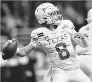  ?? Tim Warner / Getty Images ?? UT quarterbac­k Casey Thompson dueled with fellow QB Hudson Card during Saturday’s scrimmage.