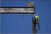  ?? MATT ROURKE — THE ASSOCIATED PRESS ?? An ironworker guides a beam during constructi­on of a municipal building in Norristown, Pa.