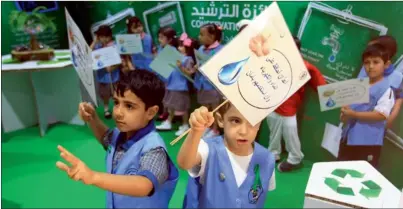  ?? KT photo by Shihab ?? Children promoting ‘Green Week’ on the opening day of Wetex 2014 at the Dubai World Trade Centre on Monday. —