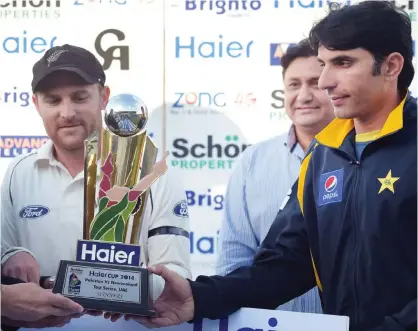  ??  ?? SHARJAH: New Zealand cricket captain Brendon McCullum (left) and his Pakistani counterpar­t Misbah-ul-Haq (right) hold a Test series trophy during a ceremony at the end of the third and final Test match between New Zealand and Pakistan at the Sharjah...