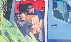  ?? ?? Homeland Security Investigat­ion agents load a box into a car at the entrance of Combs’s home at Star Island in Miami Beach.