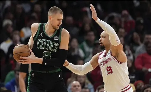  ?? DAVID J. PHILLIP — THE ASSOCIATED PRESS ?? Houston Rockets’ Dillon Brooks (9) defends against Boston Celtics’ Kristaps Porzingis (8) during the second half of an NBA basketball game Sunday, Jan. 21, 2024, in Houston.