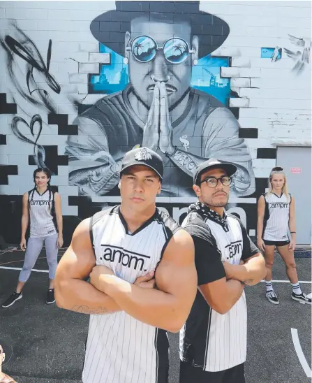  ??  ?? From left: Hayley Mabbett, Dylan Cartwright, Jeremiah Uzelpasaci and Morgan-Rose Moroney in front of the mural which now adorns the AMPM gym and depicts Johann Ofner (left) who died a year ago. Main picture: GLENN HAMPSON