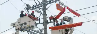  ??  ?? IN THIS PHOTO taken on April 10, 2014, electricia­ns from Manila Electric Company ( Meralco) maintain a secondary transmissi­on line in Manila. Meralco is the largest electric distributi­on utility in the Philippine­s, a 110 years old company that serves...