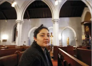  ?? KATHYWILLE­NS — THE ASSOCIATED PRESS ?? In this photo, Amanda Morales, 33, poses for a photograph in the sanctuary of the Holyrood Episcopal Church, the Bronx borough of New York. Morales has been living in two small rooms of the gothic church at the northern edge of Manhattan since August,...