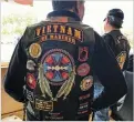  ?? REBECCA MOSS/THE NEW MEXICAN ?? LEFT: Roland Vigil, 69, of Nambe Pueblo was volunteeri­ng at the HarleyDavi­dson store in Santa Fe when motorcycis­ts rode through town for the Run for the Wall ride Friday. He wears 15 patches on the back of his jacket, including a bald eagle, a ‘Native...