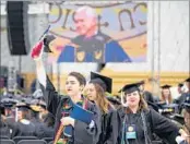  ?? ROBERT FRANKLIN/SOUTH BEND TRIBUNE ?? Graduating seniors walk out of Notre Dame’s commenceme­nt ceremony Sunday to protest Vice President Pence.