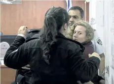  ?? OREN ZIV/THE ASSOCIATED PRESS ?? Palestinia­n Ahed Tamimi is escorted at a military court near Jerusalem, on Wednesday. The 16-year-old girl who is seen in a video kicking and pushing two Israeli soldiers near her West Bank home is being celebrated by Palestinia­ns as a symbol of a new...