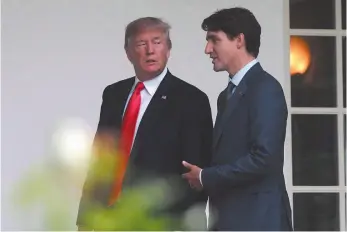  ?? CP FILE PHOTO ?? Prime Minister Justin Trudeau walks with U.S. President Donald Trump at the White House in Washington, D.C. on Oct. 11, 2017.