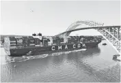  ?? SETH WENIG/AP ?? The CMA CGM Marco Polo passes Thursday underneath the Bayonne Bridge linking New Jersey and New York. The ship, which is on the East Coast for the first time, is more than three-and-a-half football fields long and can carry 16,000 20foot containers.