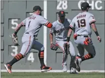  ?? CHARLES KRUPA - THE ASSOCIATED PRESS ?? San Francisco Giants center fielder Kevin Pillar (1), shortstop Mauricio Dubon (19) and left fielder Joey Rickard, center, all chase down a single by Boston Red Sox’s Rafael Devers during the second inning of a baseball game at Fenway Park in Boston, Thursday, Sept. 19, 2019.