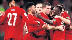  ??  ?? On course: Naby Keita is all smiles as he laps up the adulation from team-mates after breaking the deadlock early in the game