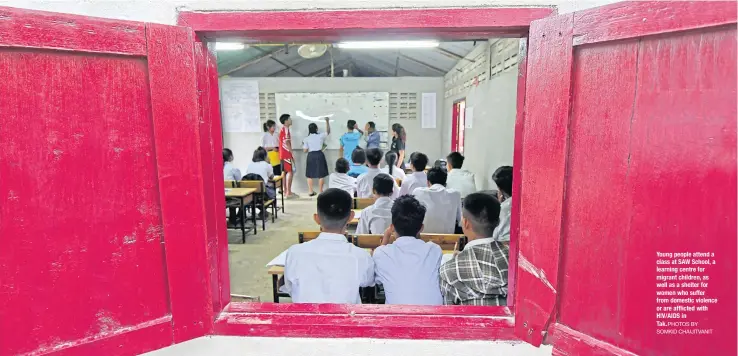  ?? PHOTOS BY SOMKID CHAIJITVAN­IT ?? Young people attend a class at SAW School, a learning centre for migrant children, as well as a shelter for women who suffer from domestic violence or are afflicted with HIV/AIDS in
Tak.