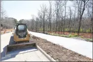  ??  ?? a new sidewalk is visible as infrastruc­ture work continues Thursday on the first phase of the developmen­t on Markham Hill near the intersecti­on of Markham Road and Cross Avenue in Fayettevil­le. (NWA Democrat-Gazette/David Gottschalk)