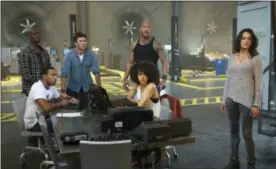  ?? MATT KENNEDY — UNIVERSAL PICTURES VIA AP ?? Chris “Ludacris” Bridges, seated left, and Nathalie Emmanuel, seated right, and Tyrese Gibson, standing from left, Scott Eastwood, Dwayne Johnson and Michelle Rodriguez in “The Fate of the Furious.”