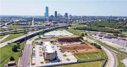  ?? [PHOTO BY DAVE MORRIS, THE OKLAHOMAN] ?? One hotel is open, another is topping out and foundation work is underway for a third just east of Bricktown where four budget hotels are planned in an industrial area along east Reno Avenue.