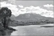  ?? ASSOCIATED PRESS ?? EMIGRANT PEAK IS SEEN RISING ABOVE the Paradise Valley and the Yellowston­e River near Emigrant, Mont., on Monday. U.S. Interior Sec. Ryan Zinke has announced a 20-year ban on new mining claims on public lands in Montana, north of Yellowston­e National Park.