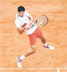  ??  ?? Serbia’s Novak Djokovic plays a backhand to Spain’s Jaume Munar during their men’s singles second round match in Paris. — AFP photo