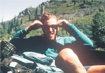  ?? For The Washington Post — Photos by Dan White ?? The author gets a li  in the back of a pickup truck during a 1993 hike of the Pacific Coast Trail.