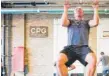  ??  ?? Gym owner Sean Griffin challenges walk- ins to do 10 pull- ups.
