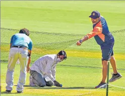  ?? PTI ?? India bowling coach Bharat Arun inspects the pitch in Ahmedabad on Wednesday.
