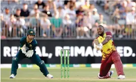 ?? Photograph: Richard Wainwright/EPA ?? Andre Russell hits out in his innings of 71 in Perth. He scored 28 from the penultimat­e over, during which he was also dropped.