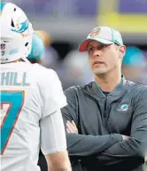  ?? JEFF HAYNES/AP ?? Miami Dolphins coach Adam Gase talks with quarterbac­k Ryan Tannehill before last week's game in Minnesota against the Vikings.