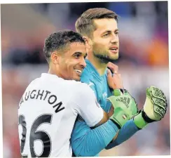  ??  ?? WE WERE JUST FAB: Kyle Naughton and Lukasz Fabianski celebrate earning crucial three points that took the Swans above relegation places