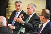  ?? GETTY IMAGES ?? Texas Gov. Greg Abbott (center) speaks Monday at the White House during a meeting of the nation’s governors with President Donald Trump. Hawaii Gov. David Ige is at left. The National Governors Associatio­n is holding its winter meetings in Washington.