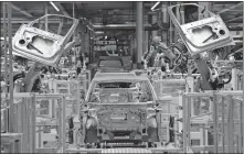  ?? FILE] ?? In this Feb. 25 photo, robots work on an electric car ID.3 body at the assembly line during a press tour at the plant of the German manufactur­er Volkswagen AG in Zwickau, Germany. [ASSOCIATED PRESS