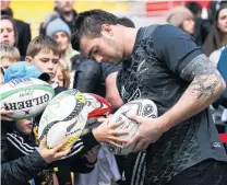  ?? PHOTO: GETTY IMAGES ?? Sign of the times . . . Liam Squire signs balls for fans during the All Black captain’s run at Westpac Stadium in Wellington yesterday.