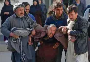  ?? — AP ?? A man is carried following a suicide attack in Kabul on Thursday.