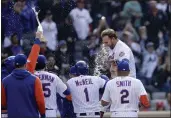  ?? ADAM HUNGER — THE ASSOCIATED PRESS ?? The Mets' Pete Alonso celebrates his walk-off two-run home run with teammates during the 10th inning against the Cardinals on Thursday in New York.