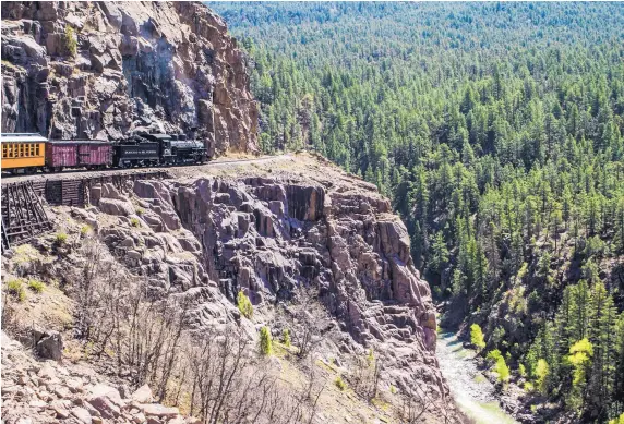  ??  ?? The Durango & Silverton Narrow Gauge Railroad clings to the cliffs high above the Animas River, riding on the same beds that were built in the early 1880s.