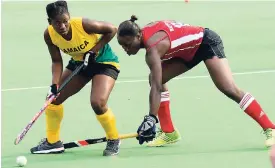  ?? FILE ?? Jamaica’s Ombretta Gordon (left) shields the ball from Guyana’s Shebeki Baptiste during the women’s final of the CAC Games hockey qualifiers earlier this month.