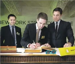  ?? Valerie Caviness European Pressphoto Agency ?? IN ITS IPO, Snap offered new shareholde­rs nonvoting stock. The move ensures that Bobby Murphy, left, and Evan Spiegel, center, can retain power in perpetuity. Above, the Snap founders with NYSE President Tom Farley.