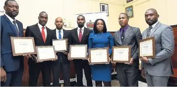  ?? PHOTO EDITOR NORMAN GRINDLEY/CHIEF ?? From left: Dameian Johnson, Dwight Sommers, Renado Harvey, Adrian Wellington, Cassandra Grant, of the Jamaica Constabula­ry Force; Noel Beckford and Anthony Ramsay of the Department of Correction­al Services, after the ceremony to hand over polygraph examiners certificat­es to participan­ts, held at the commission­er of police Old Hope Road offices, St Andrew, on Wednesday.