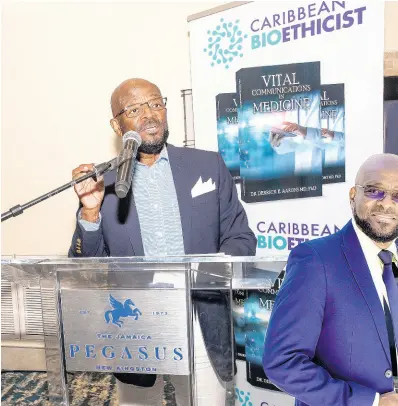  ?? CONTRIBUTE­D PHOTOS ?? The doctor and author making a presentati­on on his recently staged book launch held at the Jamaica Pegasus Hotel.